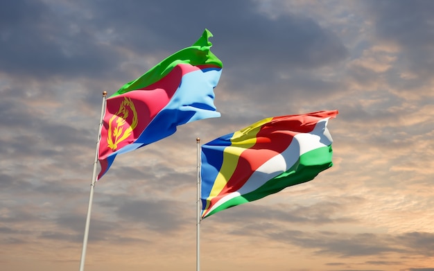 Flags of Seychelles and Eritrea on sky background