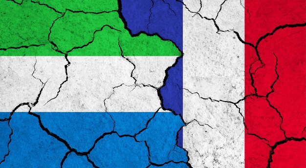 Flags of sierra leone and france on cracked surface politics relationship concept