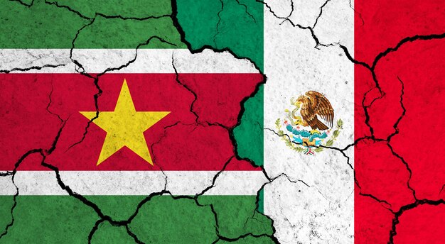 Flags of suriname and mexico on cracked surface politics relationship concept