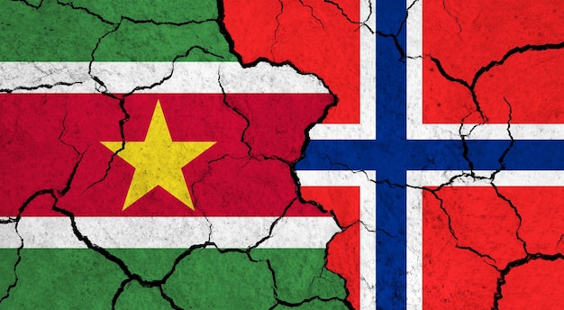 Flags of Suriname and Norway on cracked surface politics relationship concept