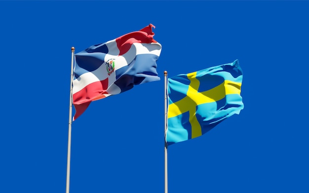 Flags of Sweden and Dominican Republic on blue sky. 3D artwork