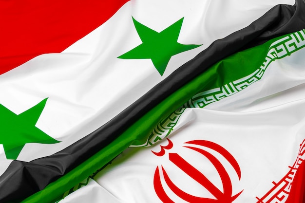 Flags of Syria and Iran together close up