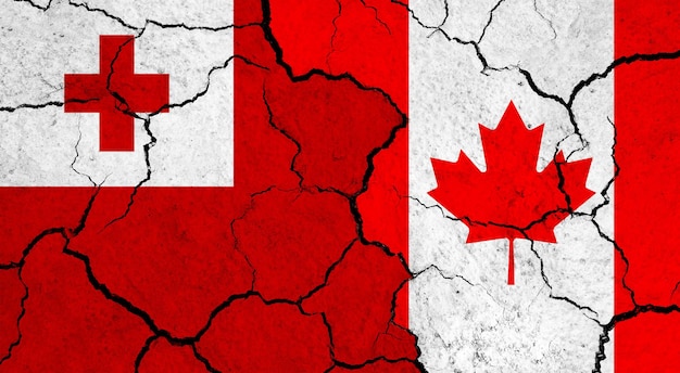 Flags of Tonga and Canada on cracked surface politics relationship concept