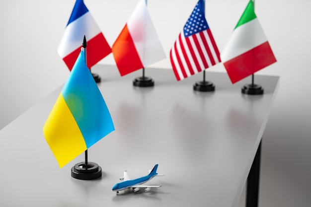 Photo flags and toy airplane close up travel concept
