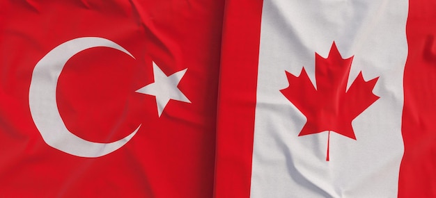 Photo flags of turkey and canada linen flag closeup flag made of canvas turkish ankara canadian state national symbols 3d illustration