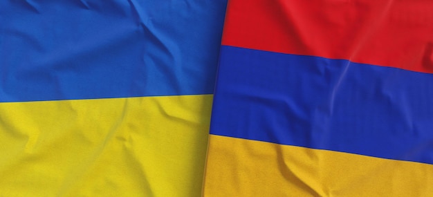 Flags of Ukraine and Armenia Linen flag closeup Flag made of canvas Ukrainian Kyiv Armenian Yerevan National symbols 3d illustration