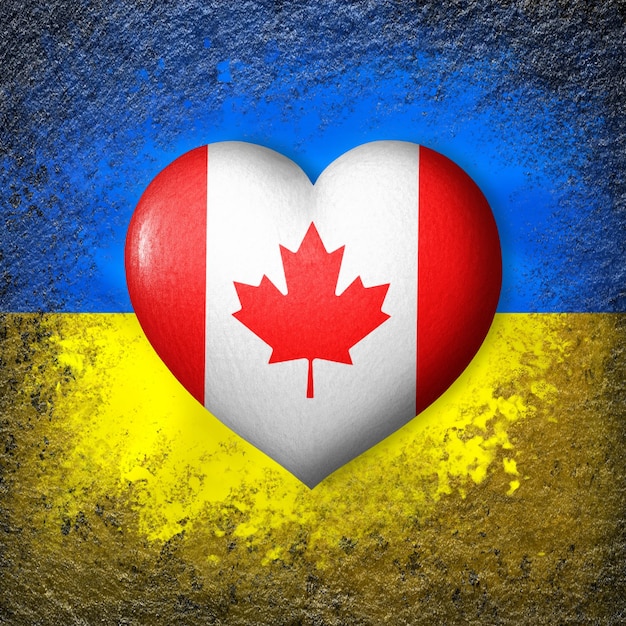 Photo flags of ukraine and canada flag heart on the background of the ukrainian flag