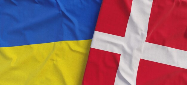 Flags of Ukraine and Denmark Linen flag close up Flag made of canvas Ukrainian Danish Copenhagen National symbols 3d illustration