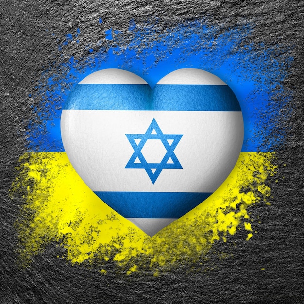 Flags of Ukraine and Israel Flag heart on the background of the flag of Ukraine painted on a stone