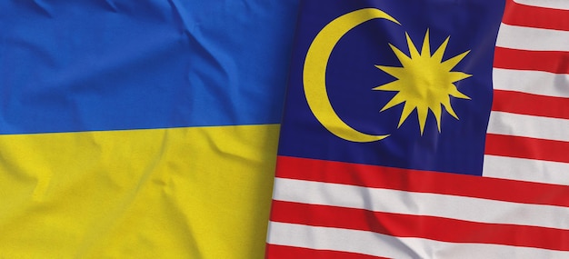 Flags of Ukraine and Malaysia Linen flag closeup Flag made of canvas Ukrainian flag Kuala Lumpur Asia State national symbols 3d illustration