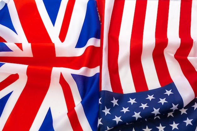 アメリカとイギリスのユニオンジャックの旗が一緒に手を振っています。