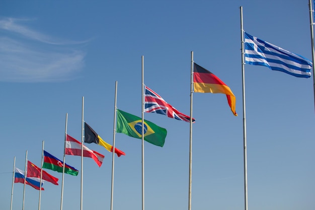 Flags of the world countries blowing in the wind on a background of the sky