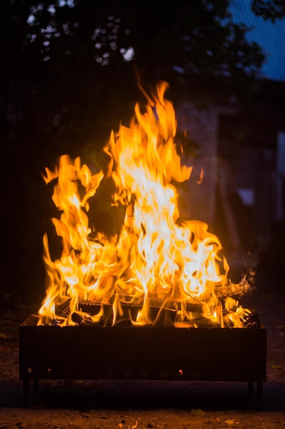 Flame rising from burning charcoal and wood in a mangal