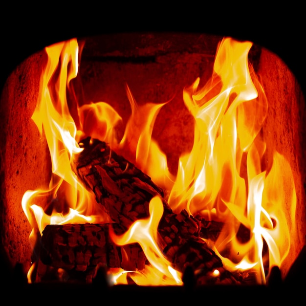 Flame of Wooden logs being burn inside stove