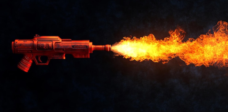फोटो a flamethrower shoots a burst of fire against a black background flamethrower flame fire powerful heat