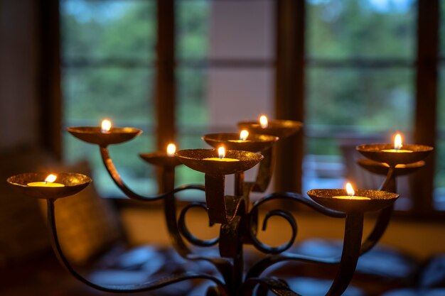 The flaming candles on a candlestick. Close up