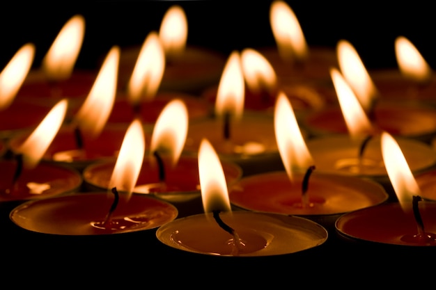 Flaming candles group Ð¾n the dark background