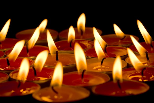 Flaming candles group in the dark background