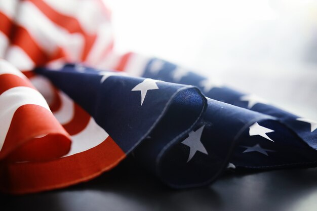 Flapping flag USA with wave. American flag for Memorial Day or 4th of July. Closeup of American flag on dark background