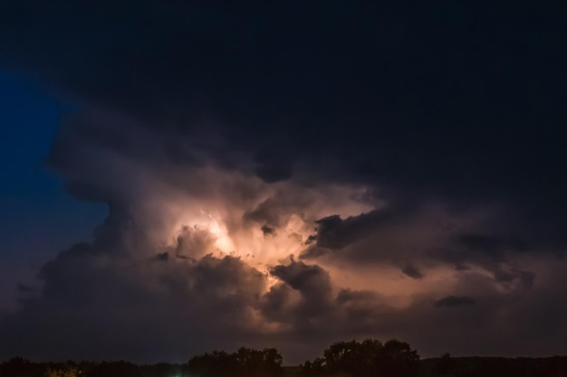 Flash of lightning on a heavy cloudy background bringing thunder bolts