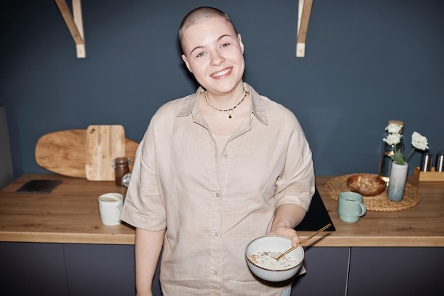 Flash portrait of young woman in kitchen