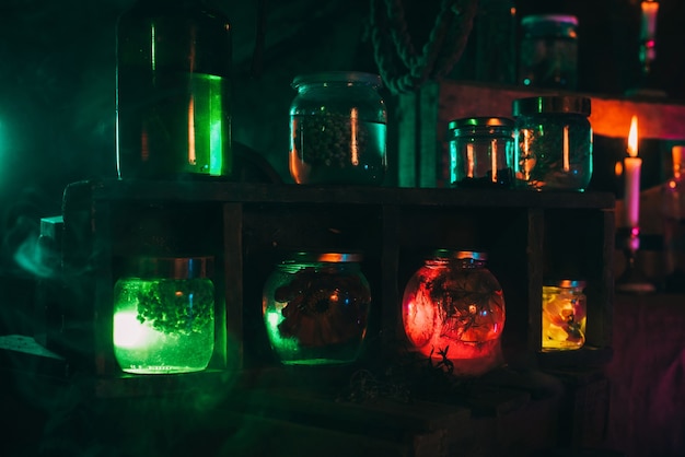 Flasks of magic potions with poison in the workshop of an alchemist witch. Interior of the mystical laboratory