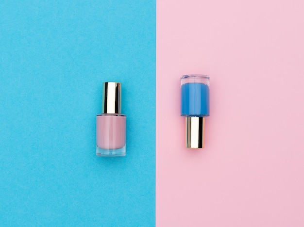 Flasks of pink and blue nail polishes