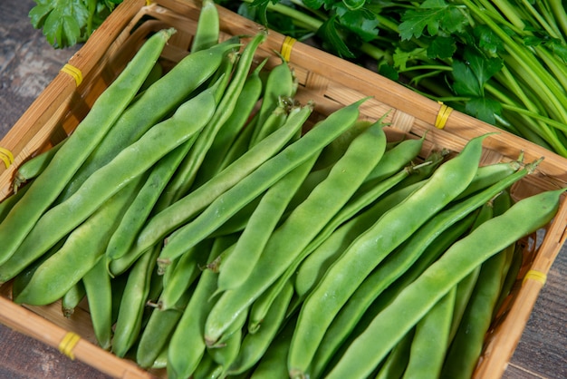 Flat beans on the wooden surface