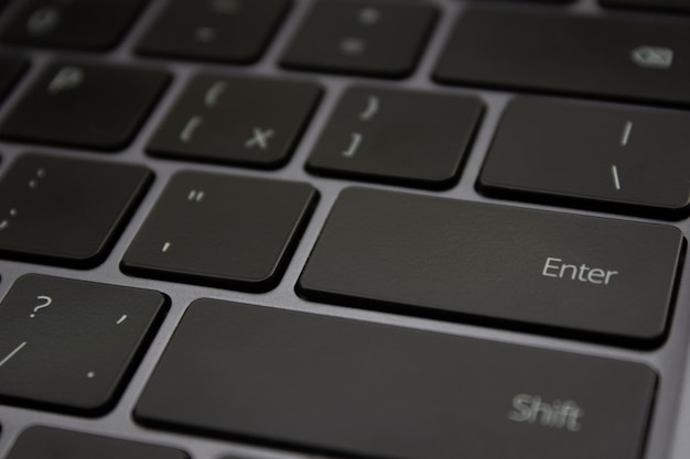 Flat black keys of laptop keyboard close up