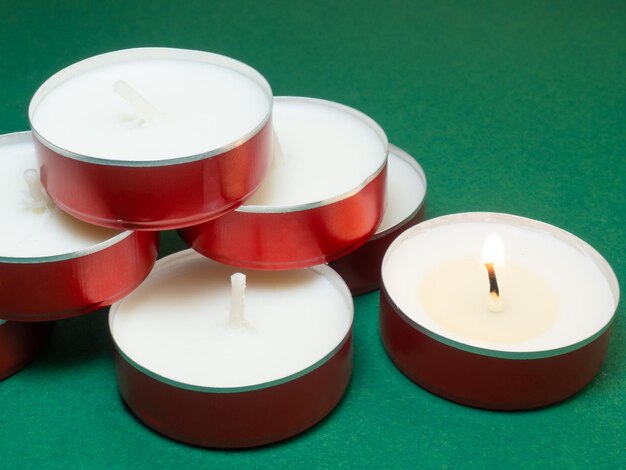 Flat candles on the table Small candles on a green background Candles not burning