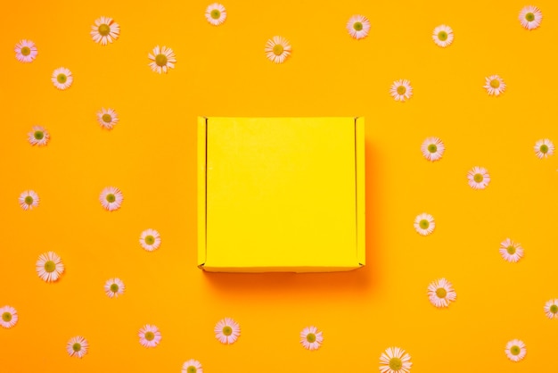 Flat cardboard box on yellow background empty inside, top view