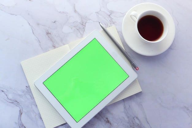 Flat composition of digital tablet and office stationary on tiles background