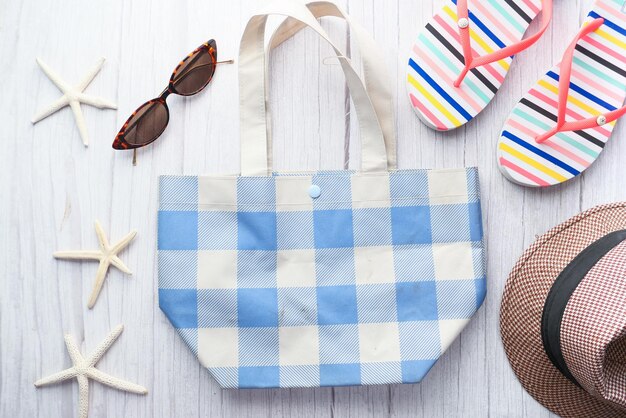 flat composition of summer beach accessories on table