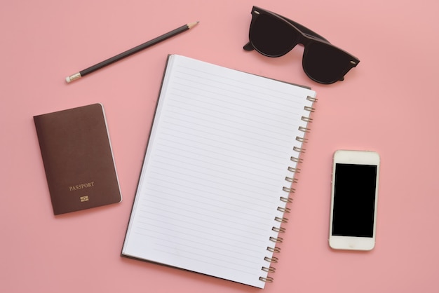 Flat Design of Workspace desk with blank notebook pencil glasses and mobile phone on Vintage pastel color background.