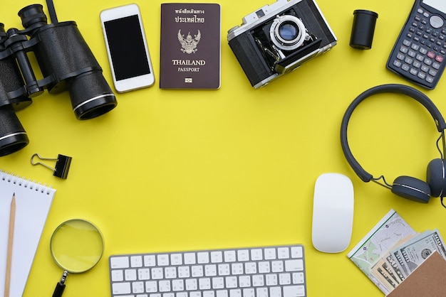 Flat lay of accessories on yellow desk background