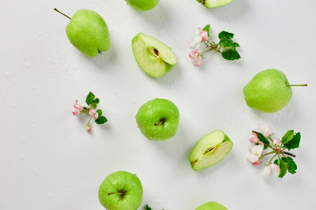 Flat lay Apple flowers and ripe green apples on a white background