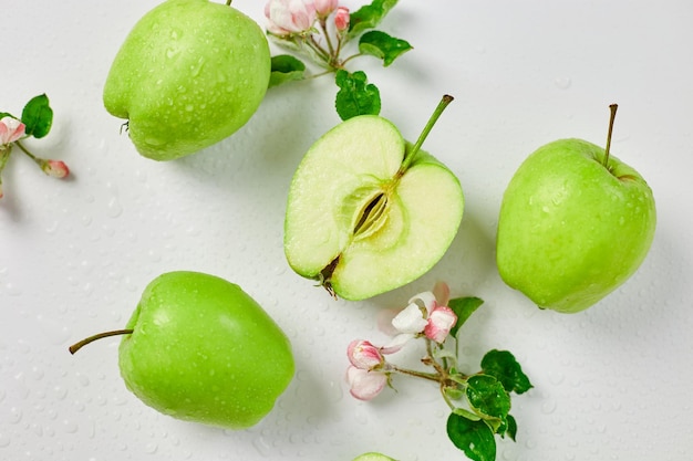 Flat lay Apple flowers and ripe green apples on a white background