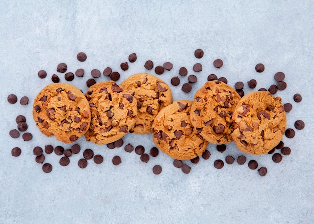 Flat lay arrangement of cookies surrounded by chocolate chips