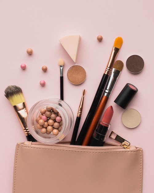 Flat lay arrangement with make-up products with beauty bag