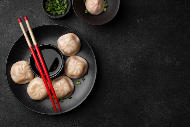 Flat lay of asian dumplings with chopsticks and copy space