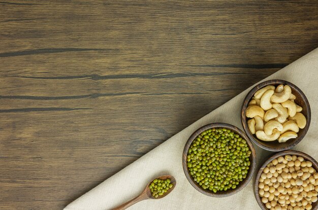 Flat lay assorted beans  on wooden table with copy space