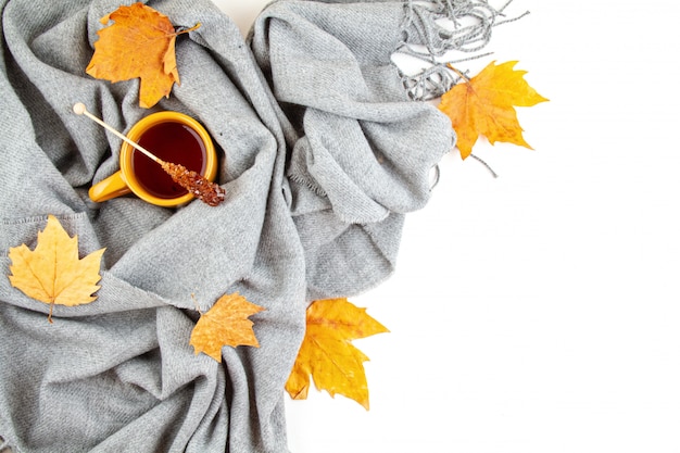 Flat lay autumn composition with cup of tea and a warm woolen scarf