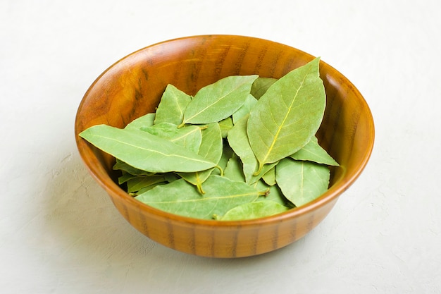 Flat lay of bay leaf in wooden bowl