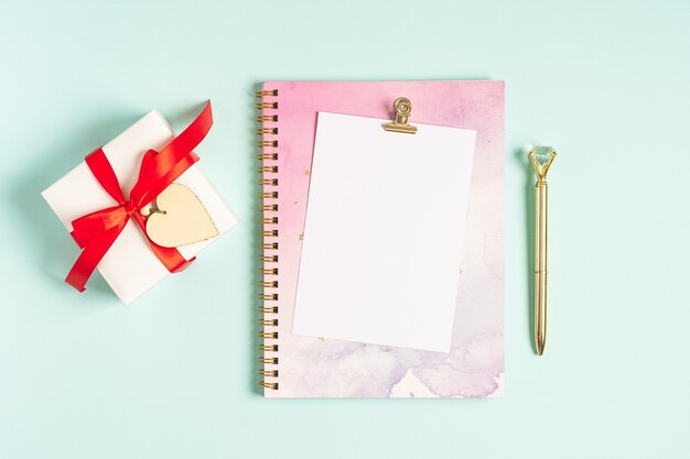 Flat lay of blank letter note pad with Valentine gift.