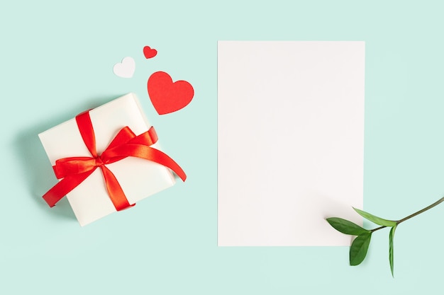 Flat lay of blank letter paper with Valentine gift.