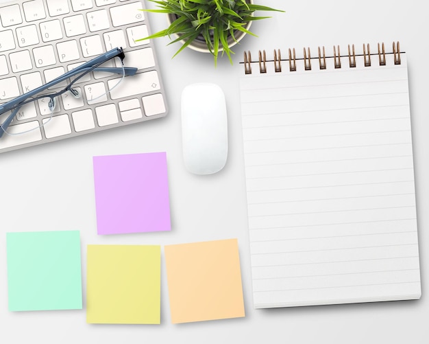 Flat lay Blank notebook computer and other office equipment on white office desk