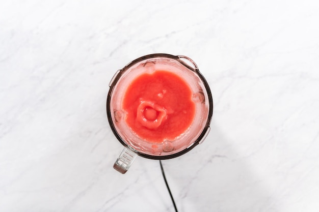 Flat lay. Blending ingredients in a kitchen blender to prepare frozen watermelon margarita.