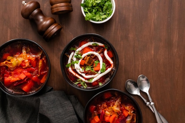 Flat lay. Borscht soup in a black bowl for dinner.