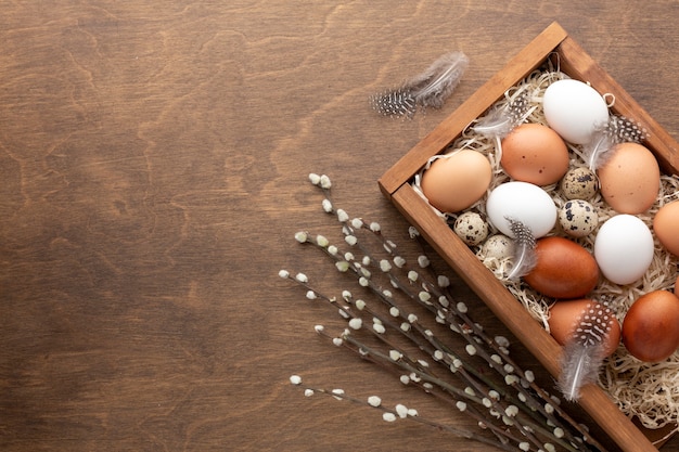 Flat lay of box with eggs for easter and copy space