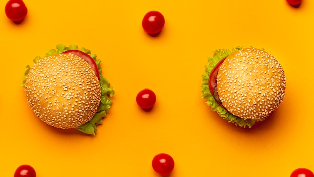 Flat lay burgers on orange background